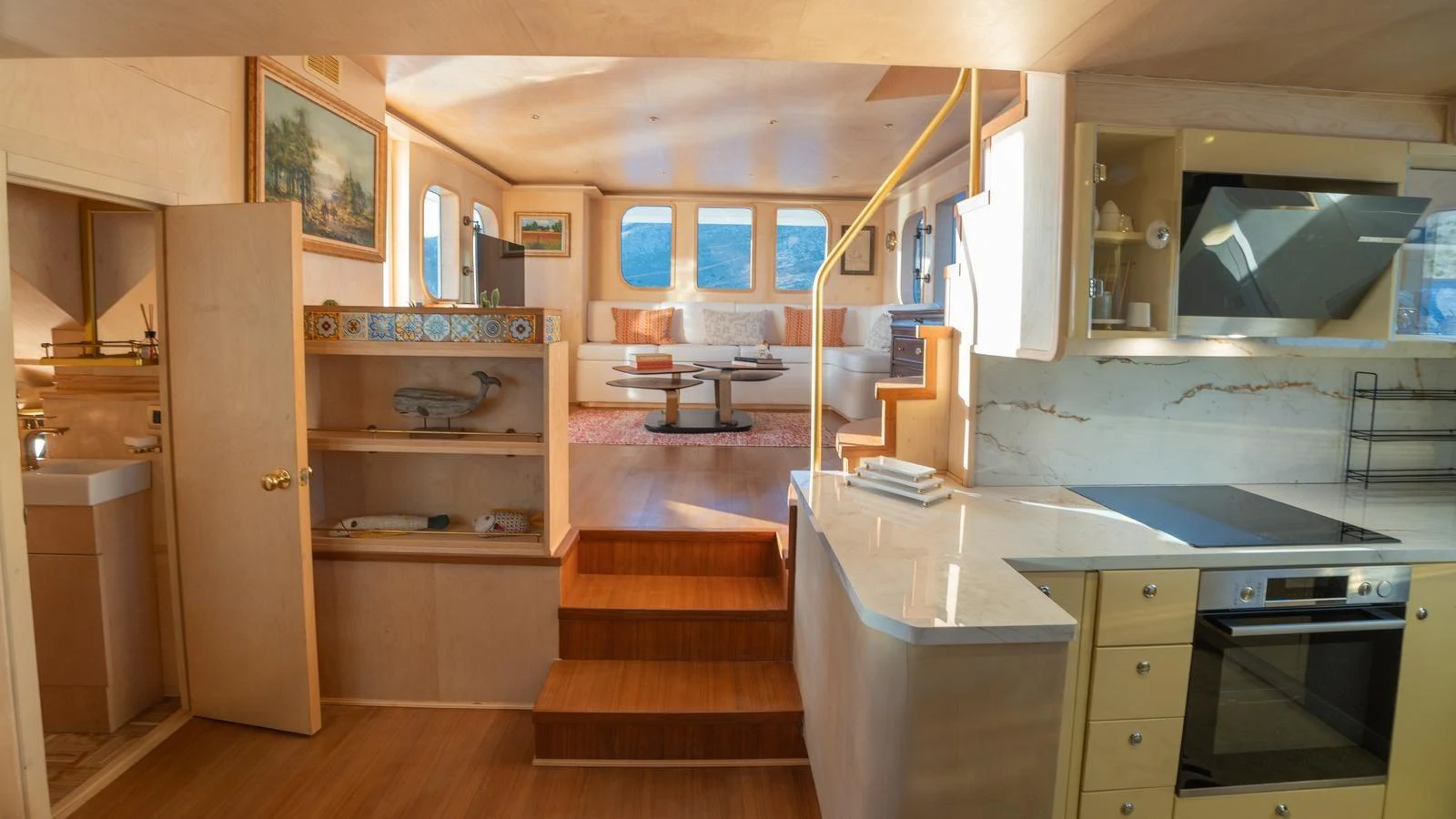 The yacht's galley and adjacent living area offer a warm and inviting space with modern amenities and stylish decor. aboard TROYWIZARD Yacht for Sale