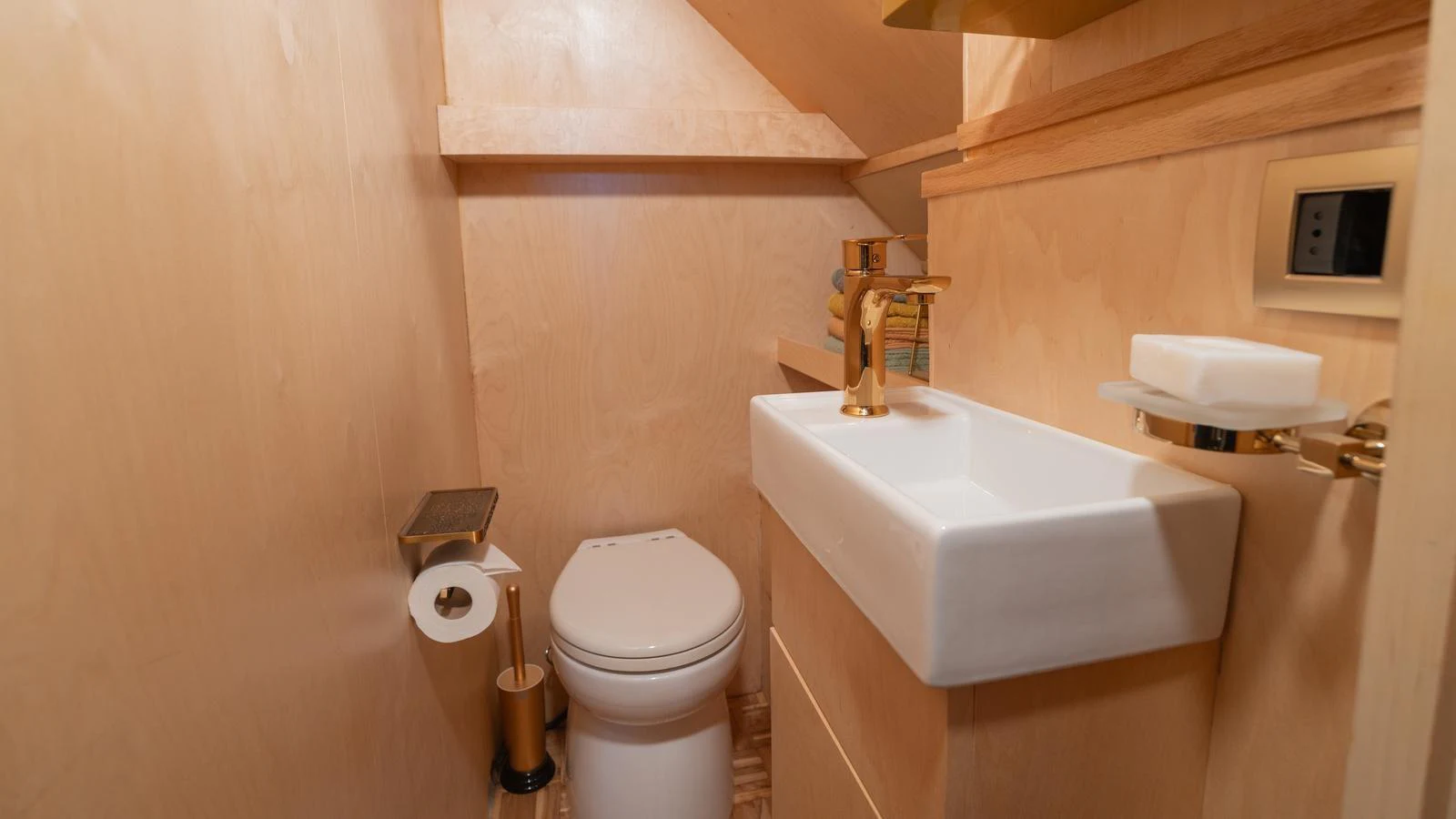 The yacht's bathroom features a modern design with elegant fixtures and light wood finishes. aboard TROYWIZARD Yacht for Sale