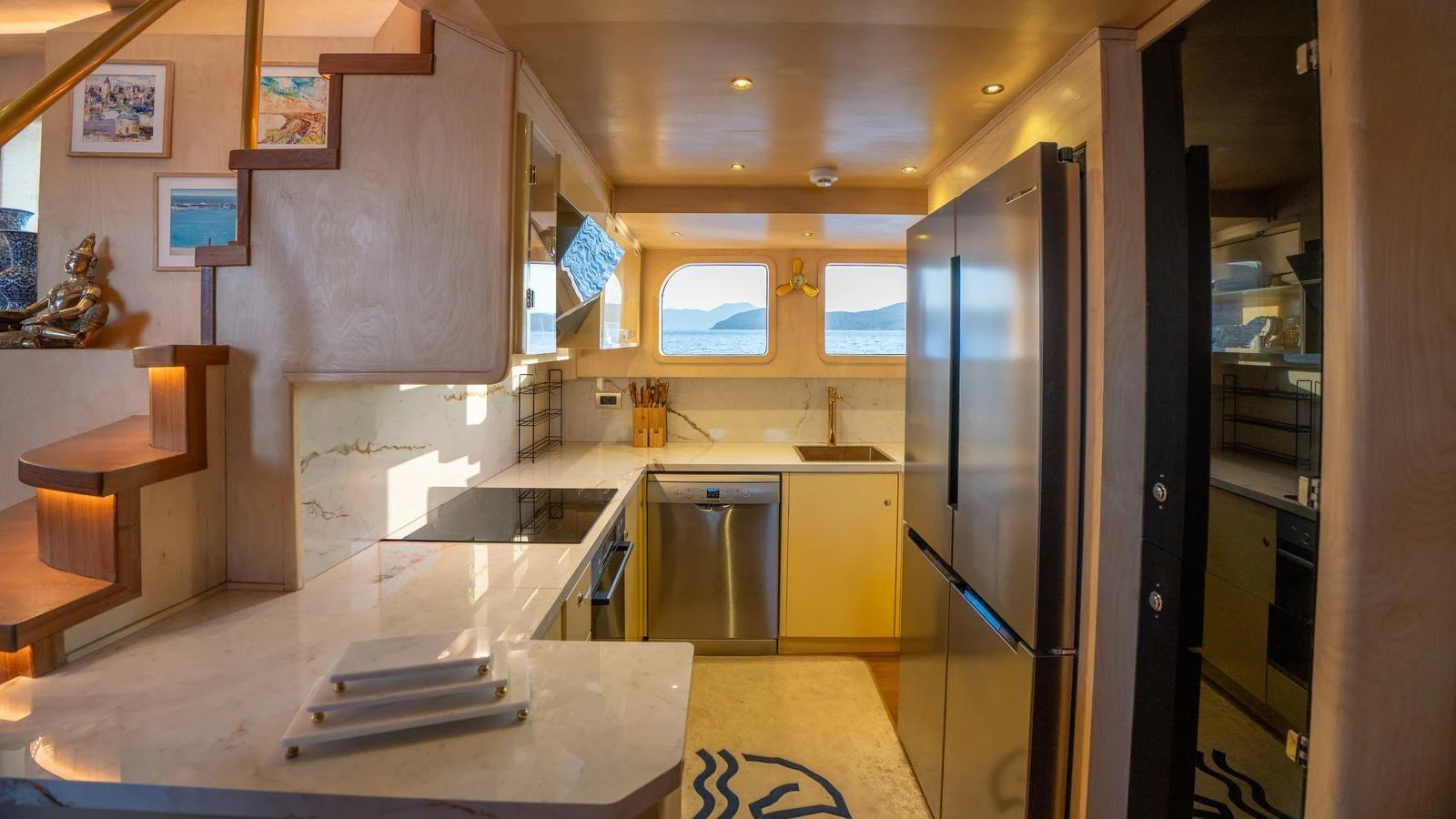 The yacht's galley is equipped with modern appliances and offers a stunning view through the windows. aboard TROYWIZARD Yacht for Sale