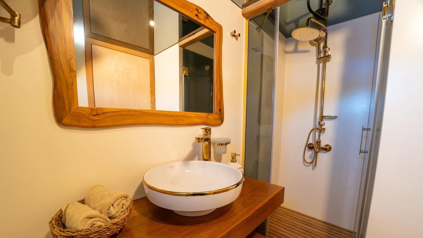 The yacht's bathroom features a stylish sink and a modern shower area. aboard TROYWIZARD Yacht for Sale