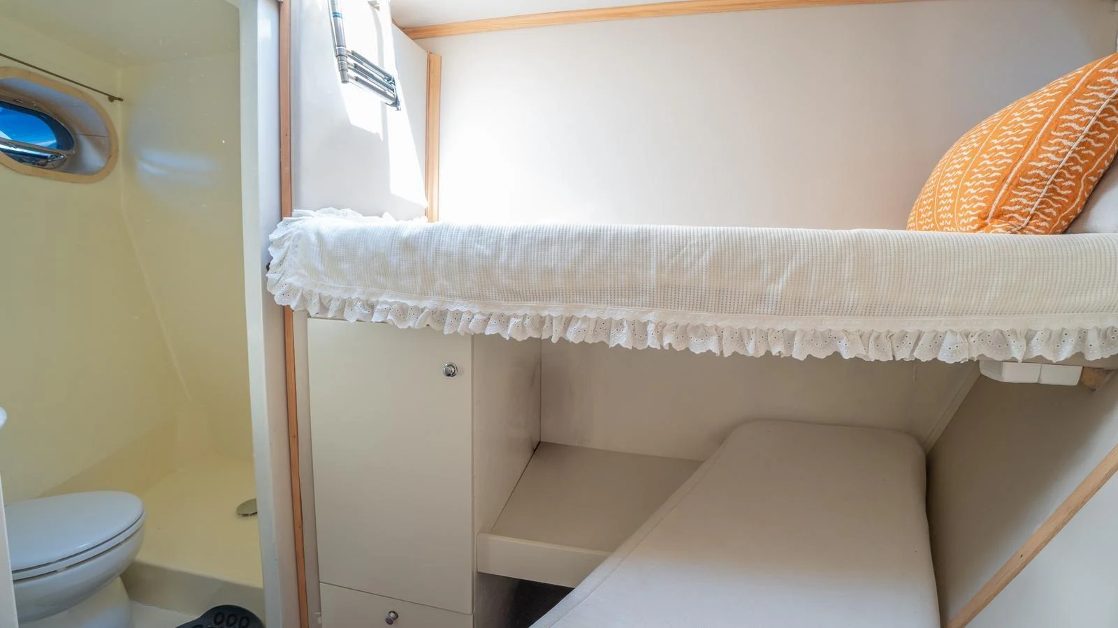 A cozy cabin with bunk beds and a small en-suite bathroom. aboard TROYWIZARD Yacht for Sale
