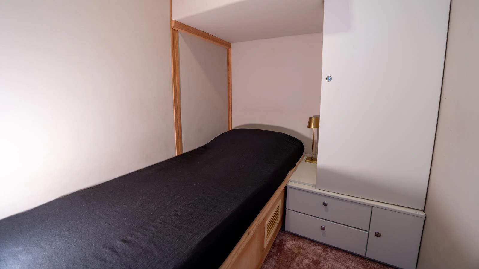 A cozy guest cabin with a single bed and built-in storage. aboard TROYWIZARD Yacht for Sale