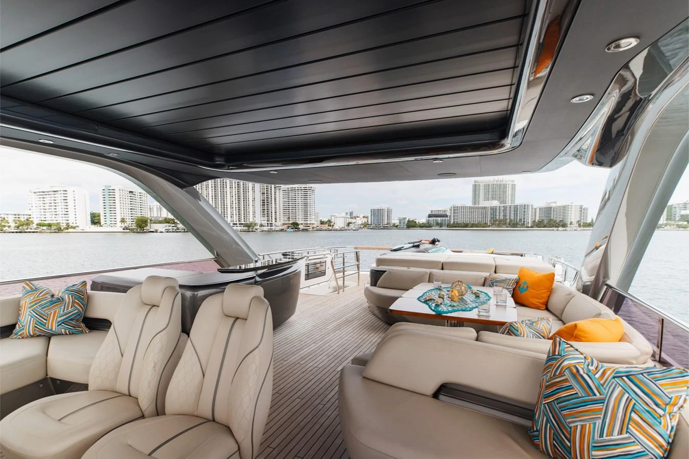 The aft deck offers a luxurious seating area with a stunning view of the waterfront. aboard TOMORROW NEVER KNOWS Yacht for Sale