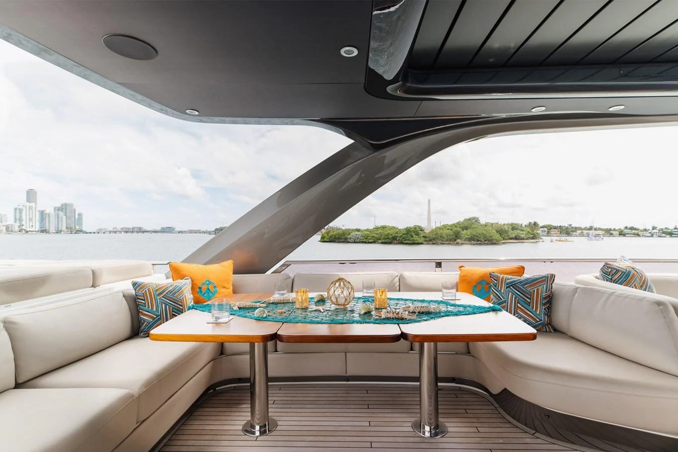 The aft deck features a stylish and comfortable seating area with a scenic view. aboard TOMORROW NEVER KNOWS Yacht for Sale