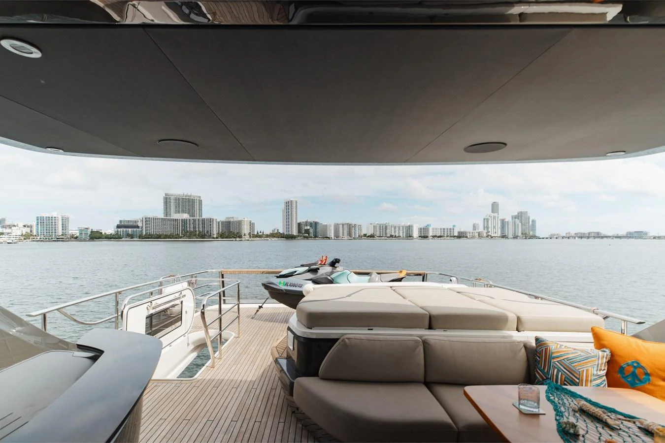 The aft deck offers a luxurious lounging area with comfortable seating and stunning views of the city skyline. aboard TOMORROW NEVER KNOWS Yacht for Sale