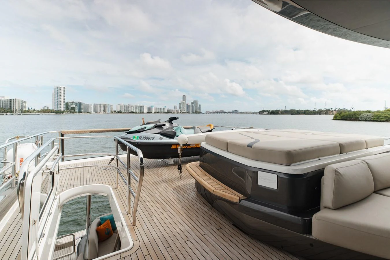The aft deck offers a spacious lounging area with a view of the water and city skyline. aboard TOMORROW NEVER KNOWS Yacht for Sale