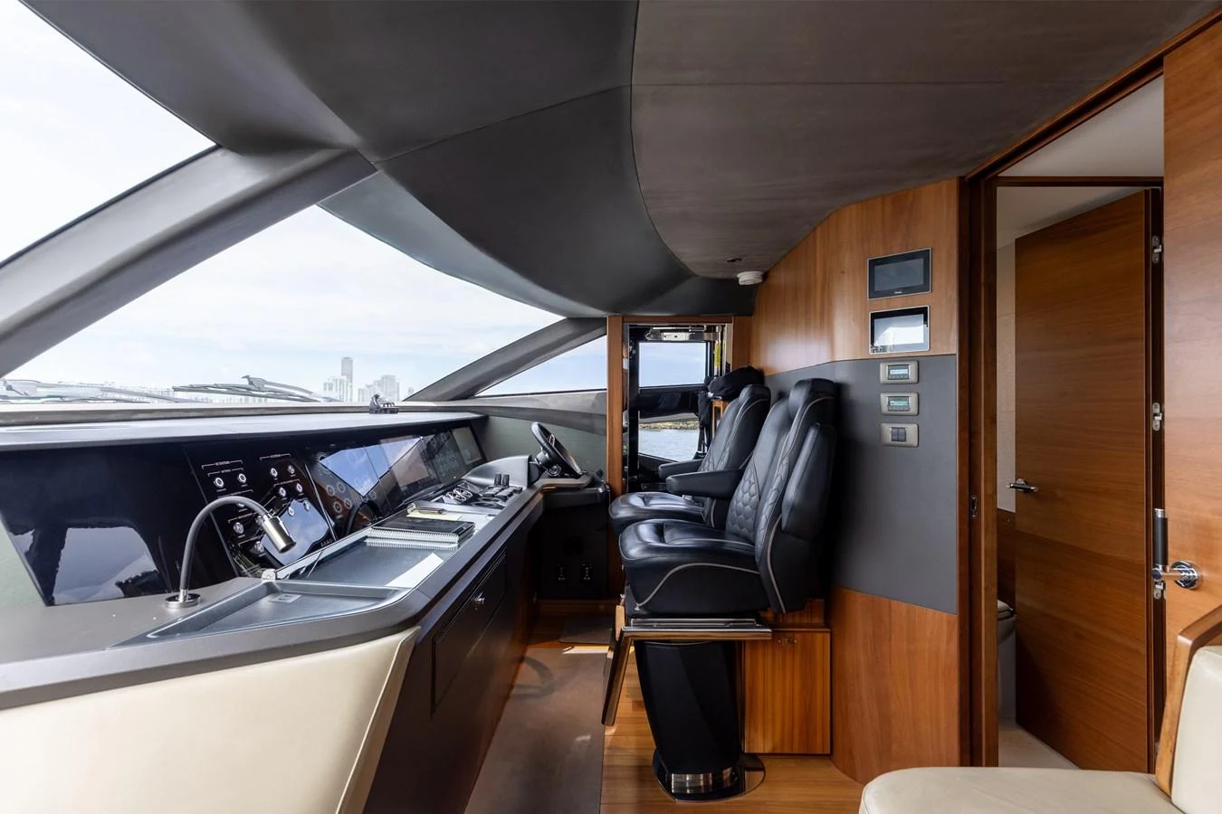 The helm station features modern navigation equipment and luxurious seating. aboard TOMORROW NEVER KNOWS Yacht for Sale