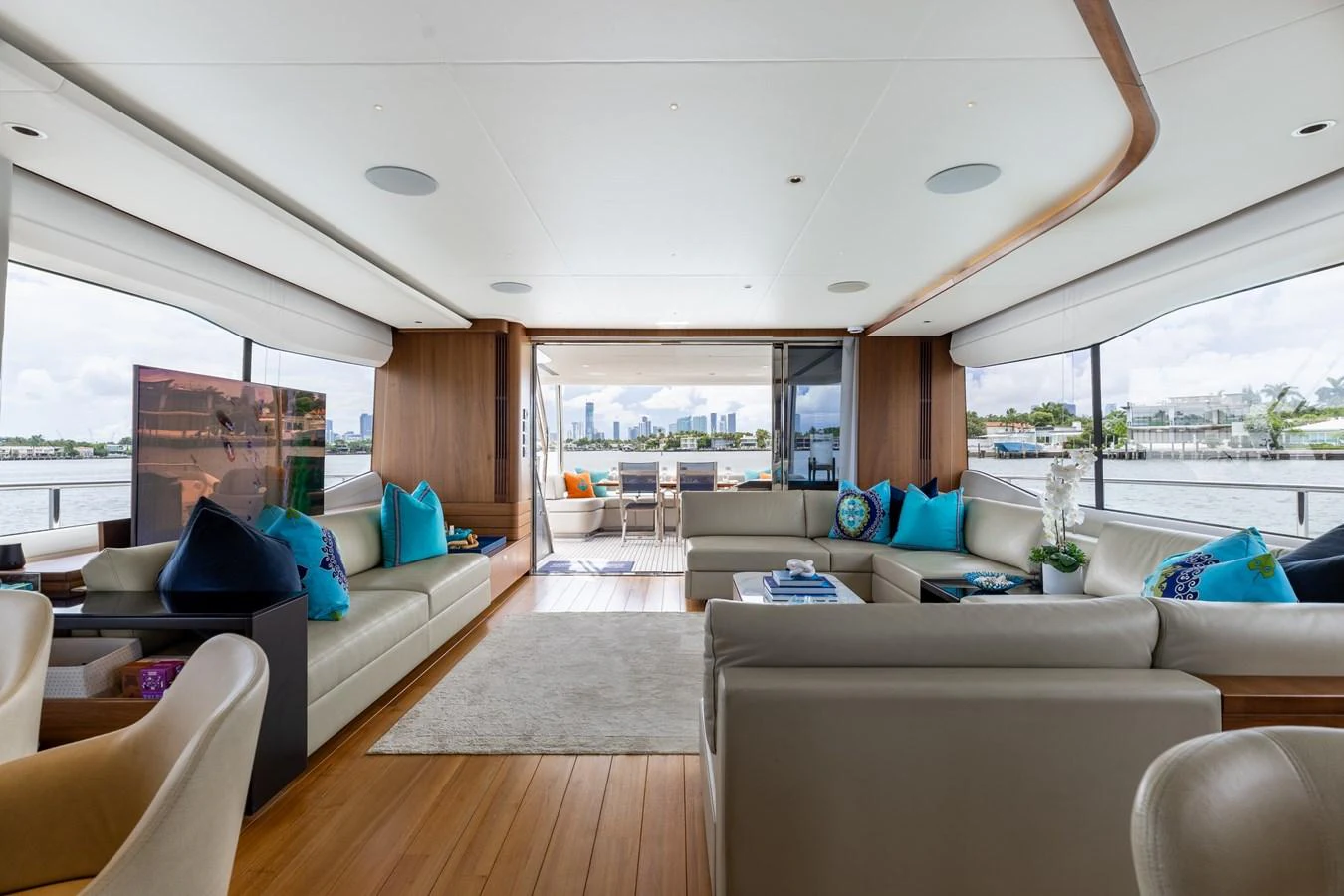 The yacht's salon offers a spacious and elegant living area with panoramic views. aboard TOMORROW NEVER KNOWS Yacht for Sale