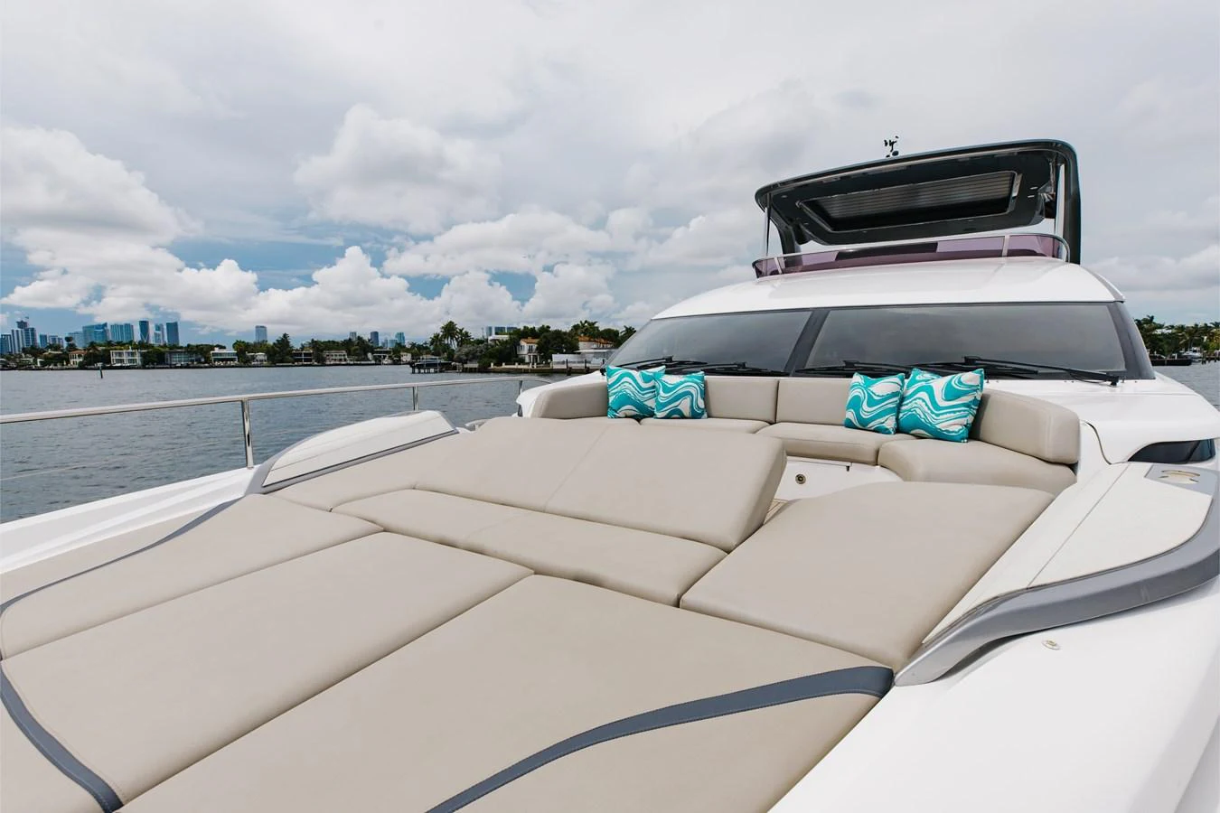 The yacht's foredeck features a spacious sunpad with plush cushions and decorative pillows, perfect for relaxation. aboard TOMORROW NEVER KNOWS Yacht for Sale