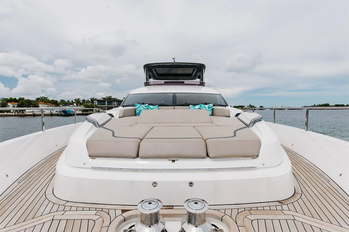 The yacht's foredeck features a spacious sunbathing area with plush cushions and scenic views. aboard TOMORROW NEVER KNOWS Yacht for Sale