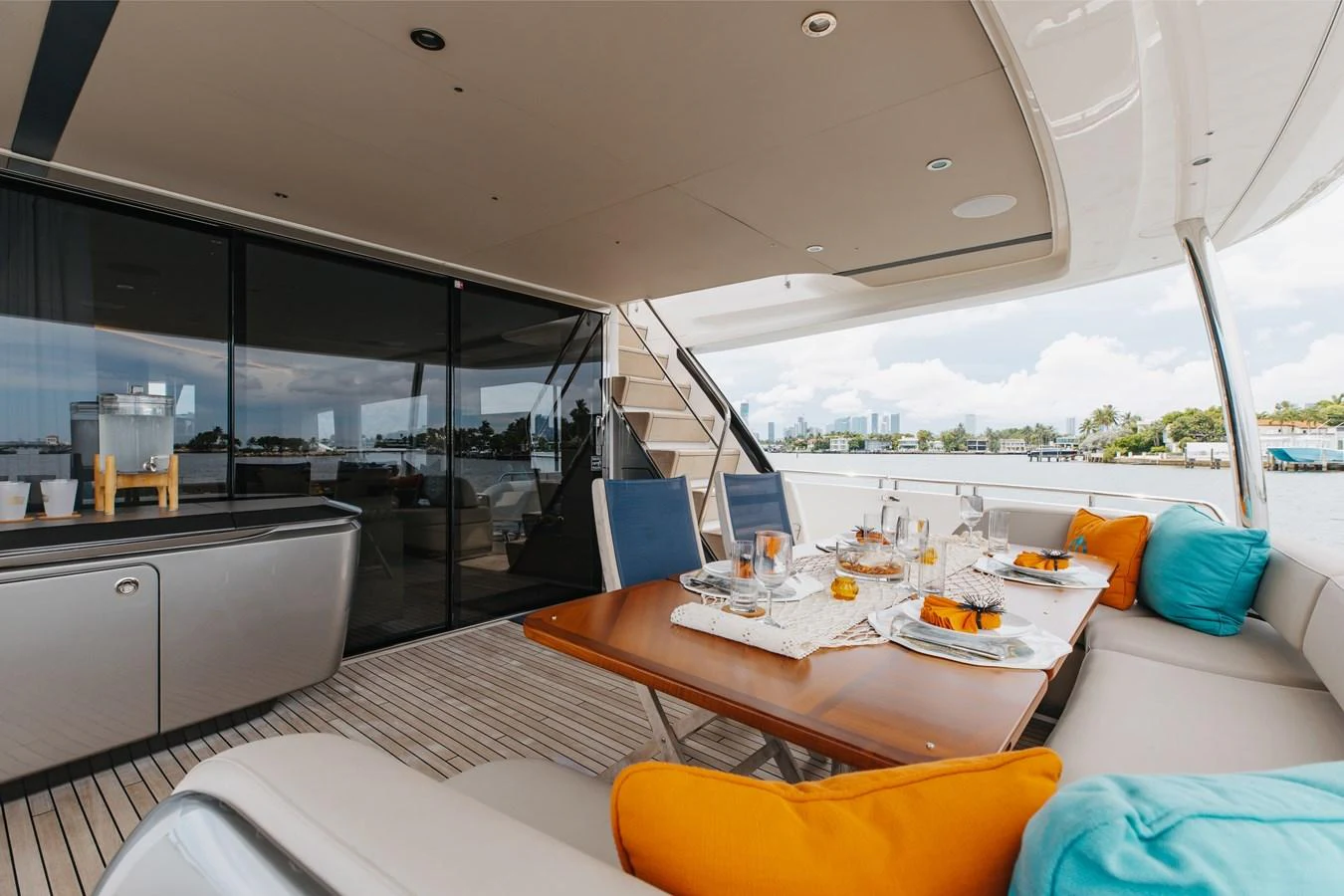 The aft deck features a stylish dining area with a view of the water, perfect for alfresco meals. aboard TOMORROW NEVER KNOWS Yacht for Sale