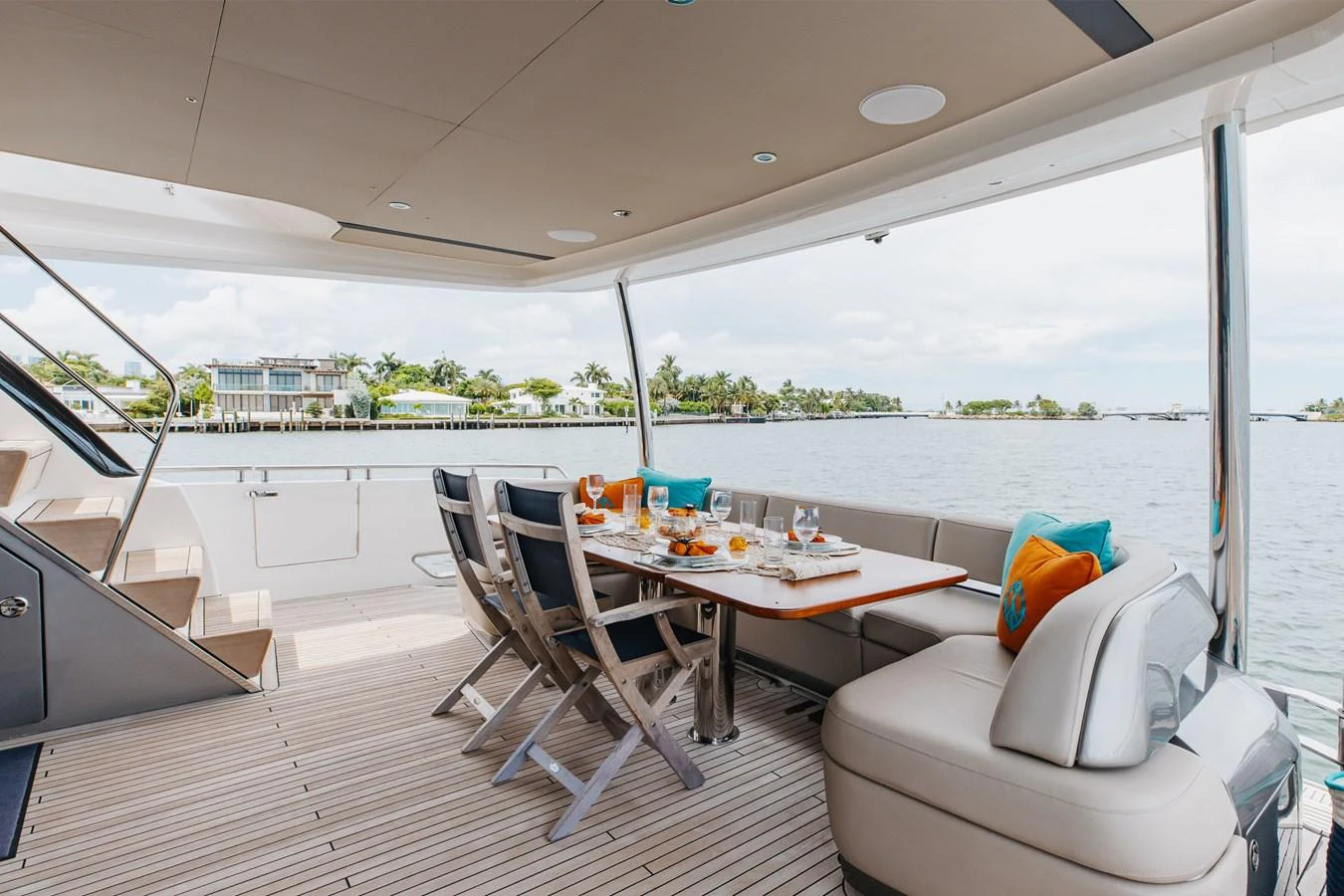 The aft deck features a stylish dining area with comfortable seating and scenic views. aboard TOMORROW NEVER KNOWS Yacht for Sale