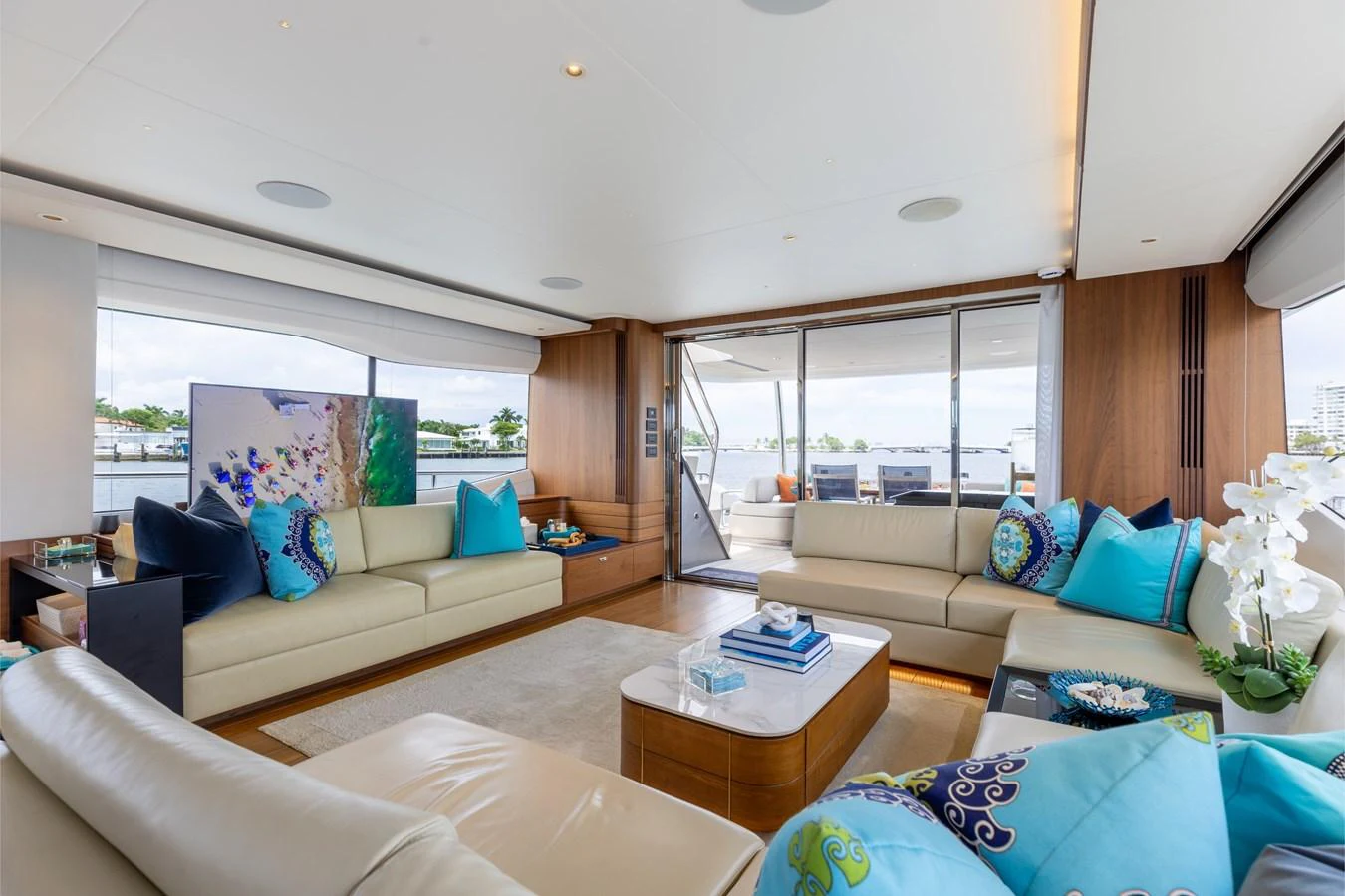 The salon offers a spacious and elegantly decorated living area with ample seating and large windows for natural light. aboard TOMORROW NEVER KNOWS Yacht for Sale