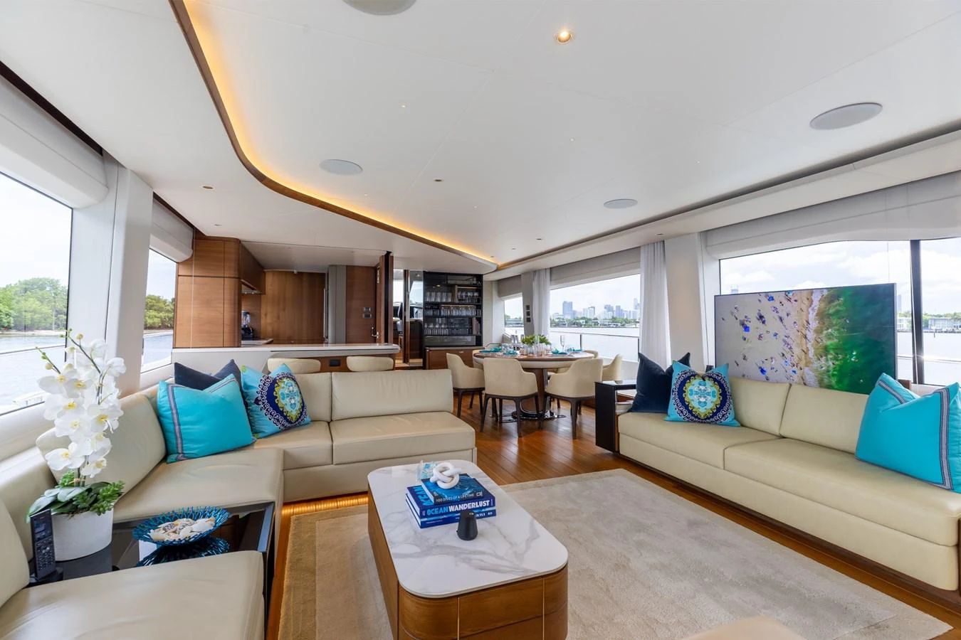 The spacious salon features elegant seating, a large TV, and panoramic windows offering stunning views. aboard TOMORROW NEVER KNOWS Yacht for Sale
