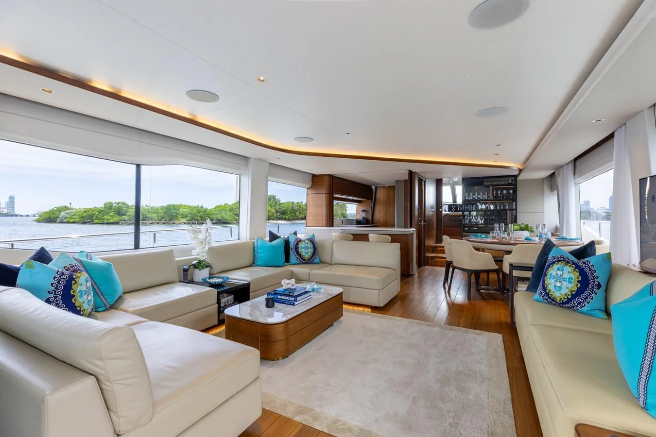 The salon offers a spacious and luxurious seating area with large windows providing stunning views. aboard TOMORROW NEVER KNOWS Yacht for Sale