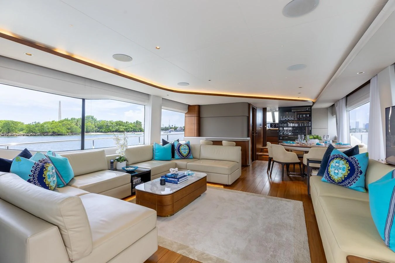 The spacious salon features plush seating and panoramic windows with a serene view. aboard TOMORROW NEVER KNOWS Yacht for Sale