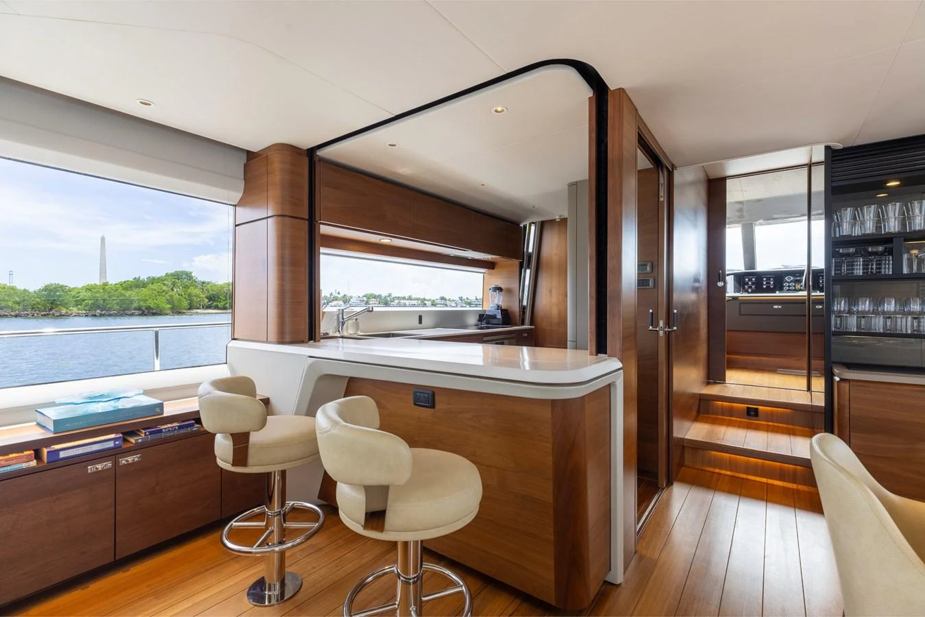 The yacht's galley features modern wood finishes and ample natural light with a view of the water. aboard TOMORROW NEVER KNOWS Yacht for Sale