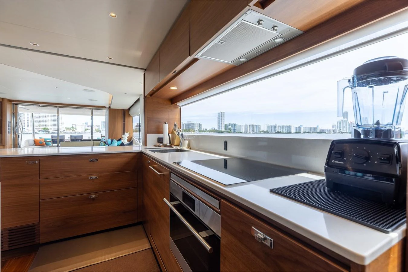 The yacht's galley features modern appliances and a sleek design with a large window offering scenic views. aboard TOMORROW NEVER KNOWS Yacht for Sale