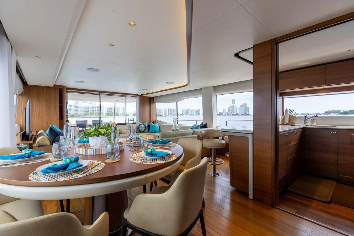 The salon features a spacious dining area with elegant table settings and a well-equipped galley. aboard TOMORROW NEVER KNOWS Yacht for Sale