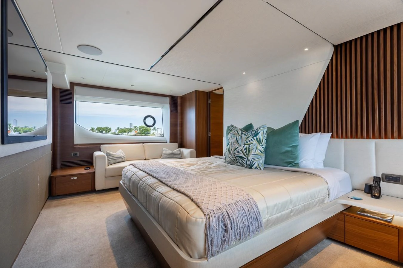 A luxurious stateroom featuring a large bed, comfortable seating, and elegant decor. aboard TOMORROW NEVER KNOWS Yacht for Sale