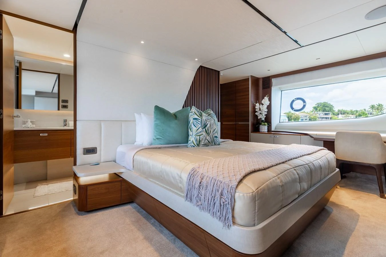 The master stateroom features a luxurious bed with plush pillows and a modern, elegant design. aboard TOMORROW NEVER KNOWS Yacht for Sale