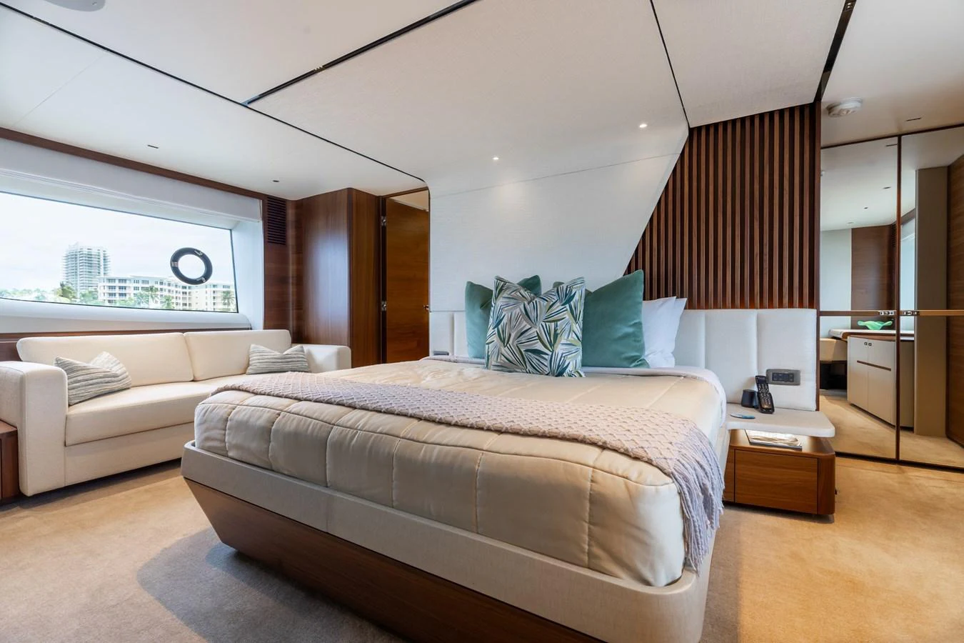 The stateroom features a luxurious bed with plush pillows and a comfortable seating area, offering a serene retreat. aboard TOMORROW NEVER KNOWS Yacht for Sale