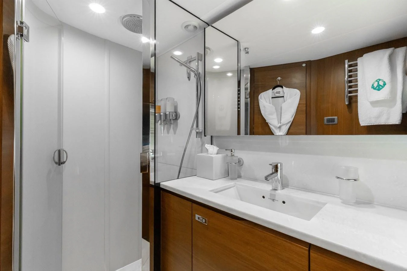 The yacht's bathroom features a sleek design with modern fixtures and ample storage. aboard TOMORROW NEVER KNOWS Yacht for Sale