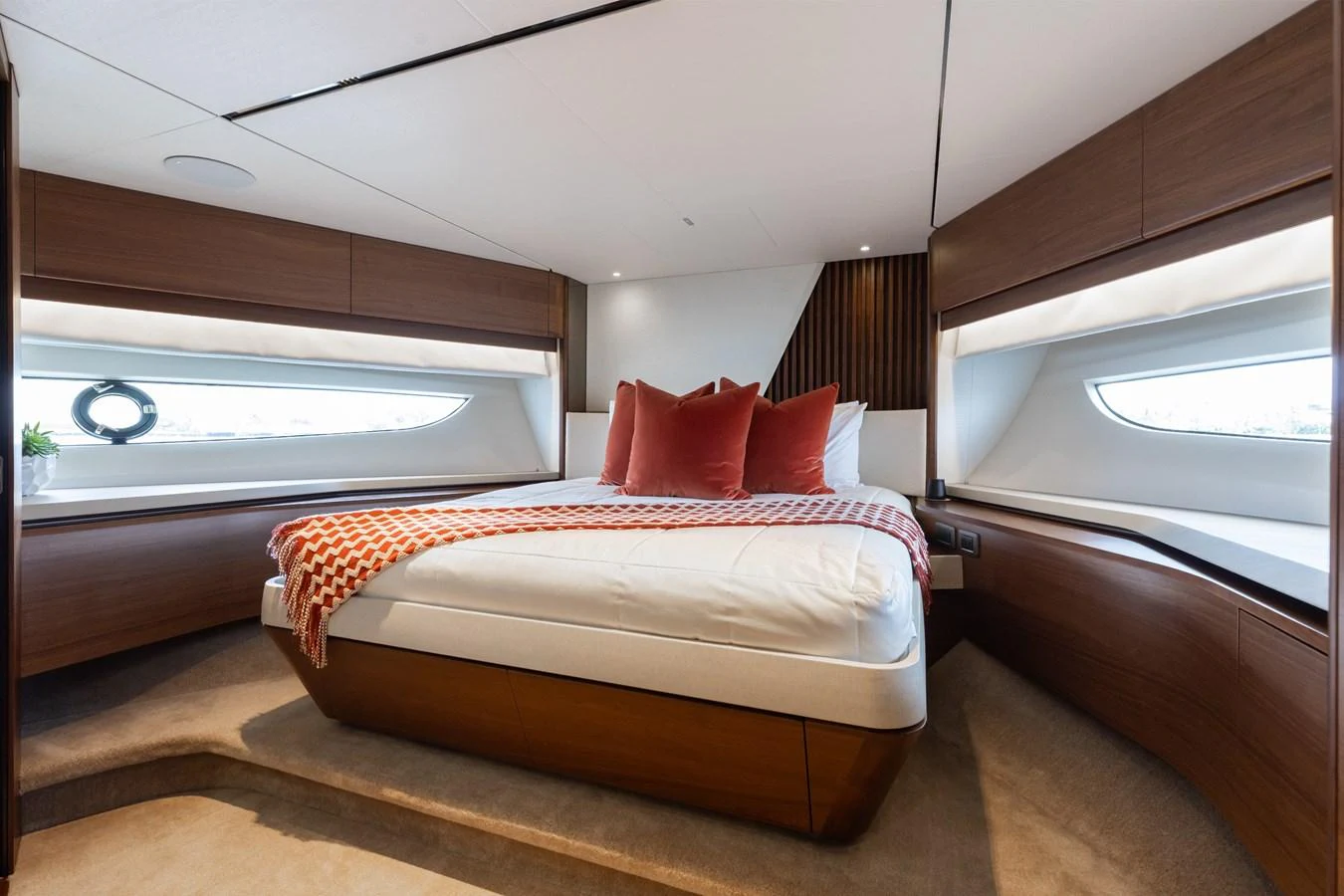 The stateroom features a luxurious bed with plush pillows and modern wooden accents, offering a serene retreat. aboard TOMORROW NEVER KNOWS Yacht for Sale