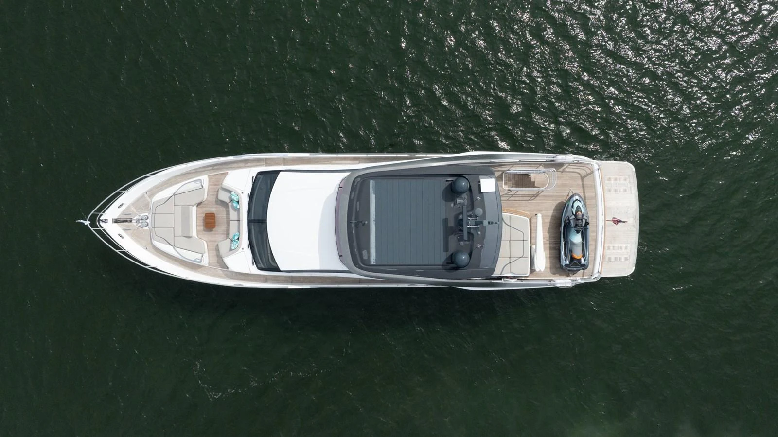 A sleek yacht is seen from an aerial view, showcasing its elegant design and spacious deck areas. aboard TOMORROW NEVER KNOWS Yacht for Sale