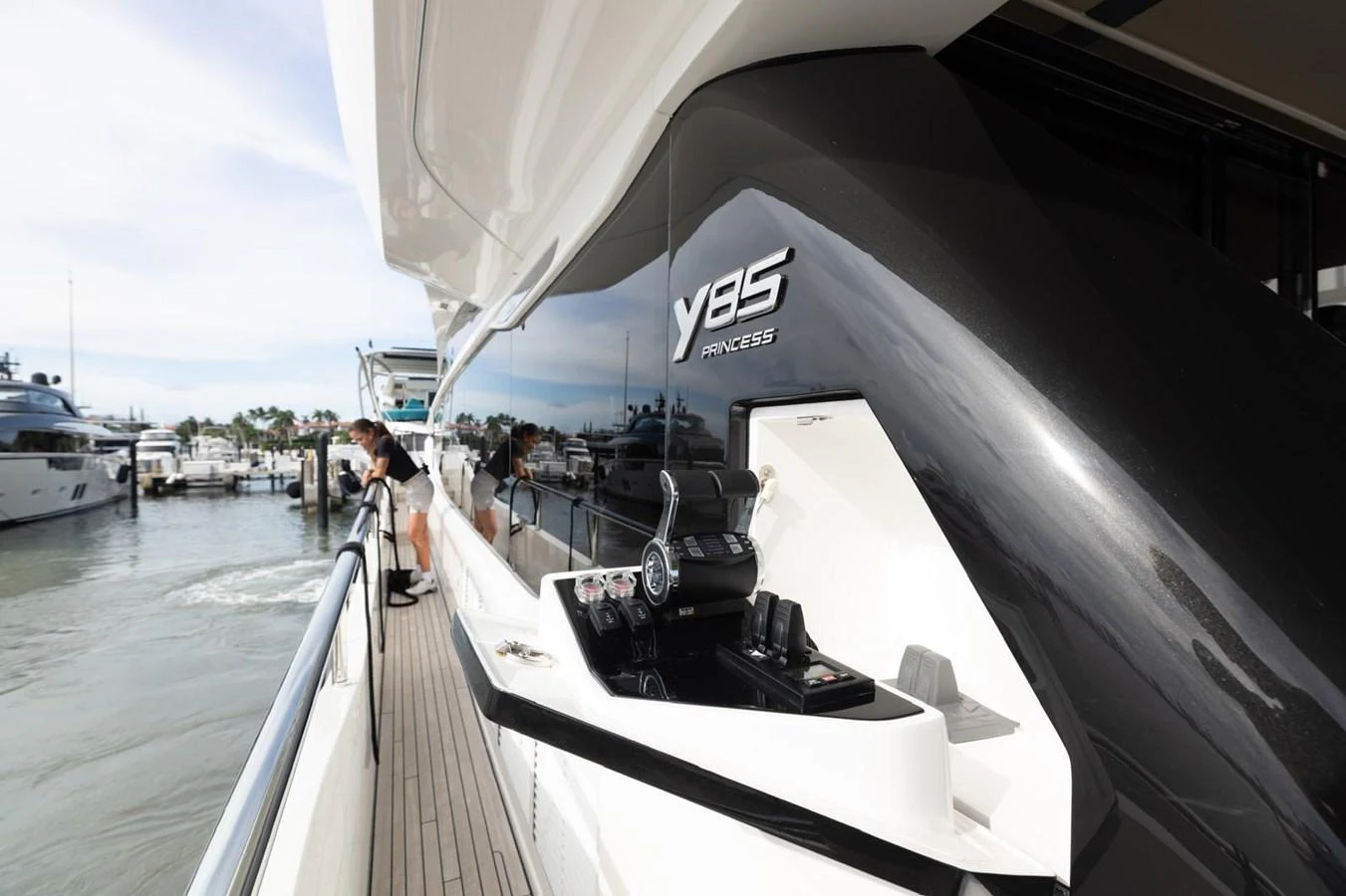 The sleek exterior of the yacht showcases its modern design and luxurious finish at the dock. aboard TOMORROW NEVER KNOWS Yacht for Sale