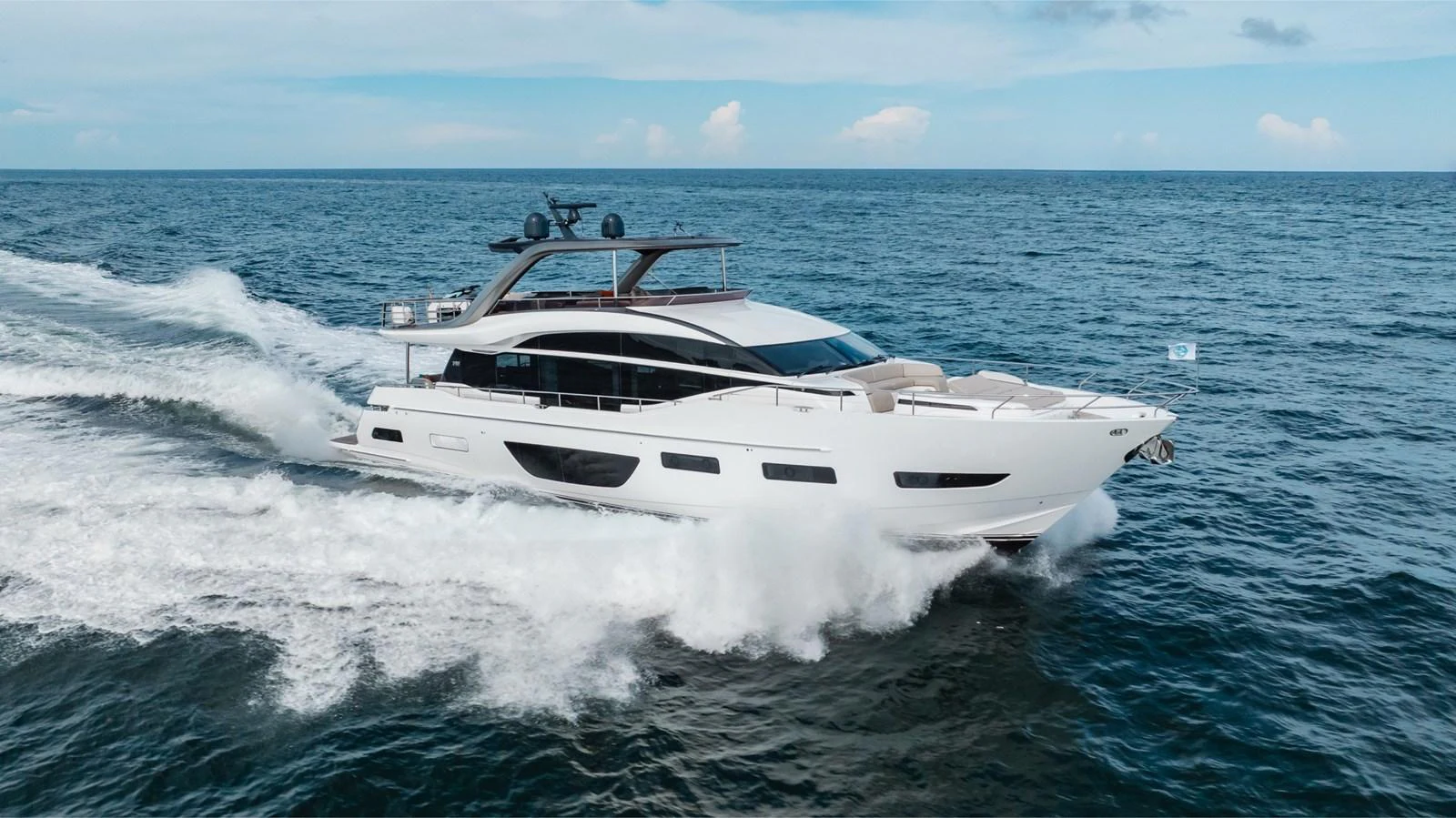 A sleek, modern yacht cruises swiftly through the open sea, showcasing its elegant design and powerful performance. aboard TOMORROW NEVER KNOWS Yacht for Sale