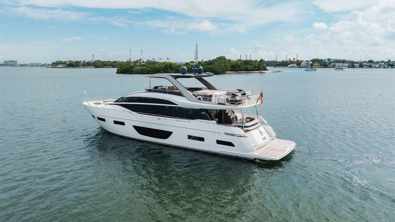 A sleek and modern yacht glides gracefully on calm waters, showcasing its elegant design and spacious decks. aboard TOMORROW NEVER KNOWS Yacht for Sale