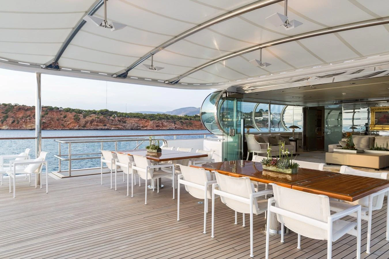 The aft deck offers a spacious and elegant outdoor dining area with stunning views. aboard ZEUS Yacht for Sale