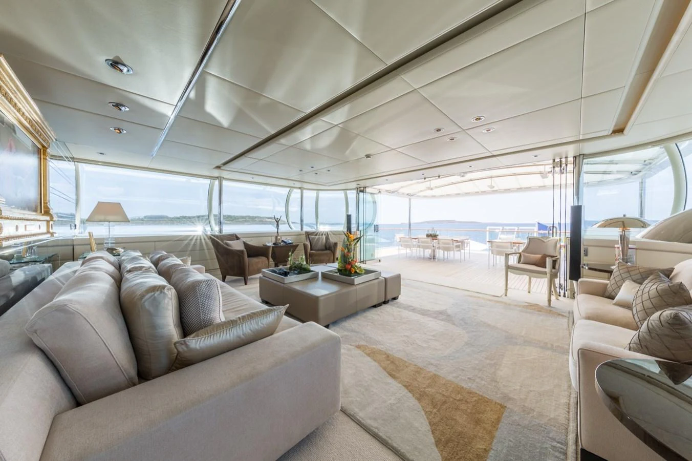 The spacious salon offers luxurious seating with a seamless transition to the outdoor deck. aboard ZEUS Yacht for Sale