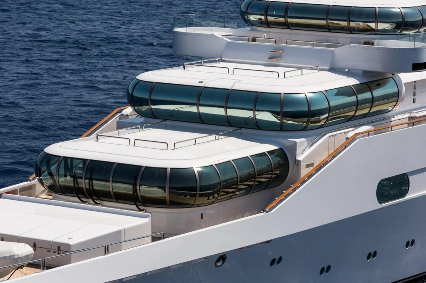 The yacht features sleek, modern lines with expansive glass windows and a pristine white exterior. aboard ZEUS Yacht for Sale