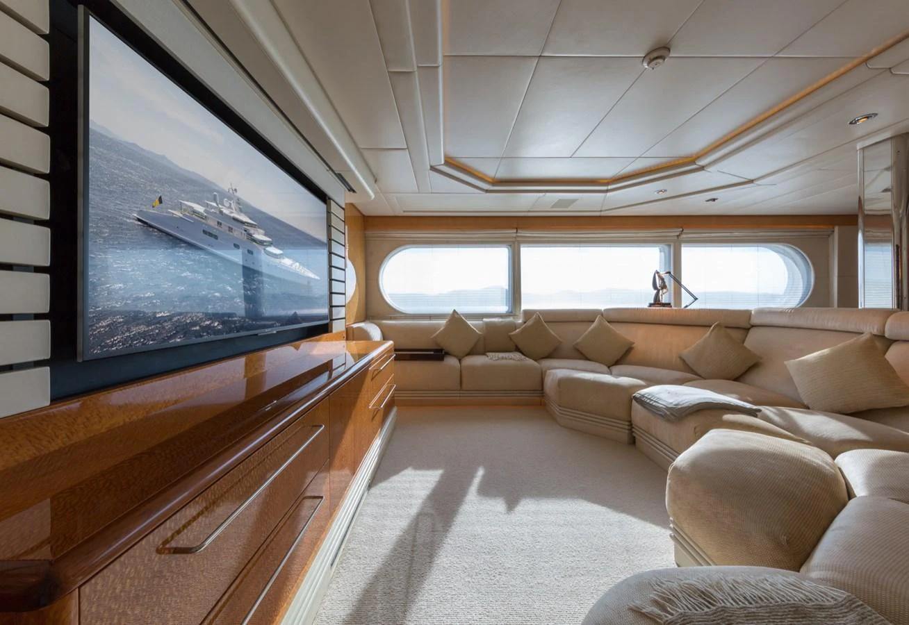 The salon features a spacious seating area with plush cushions and large windows offering panoramic views. aboard ZEUS Yacht for Sale