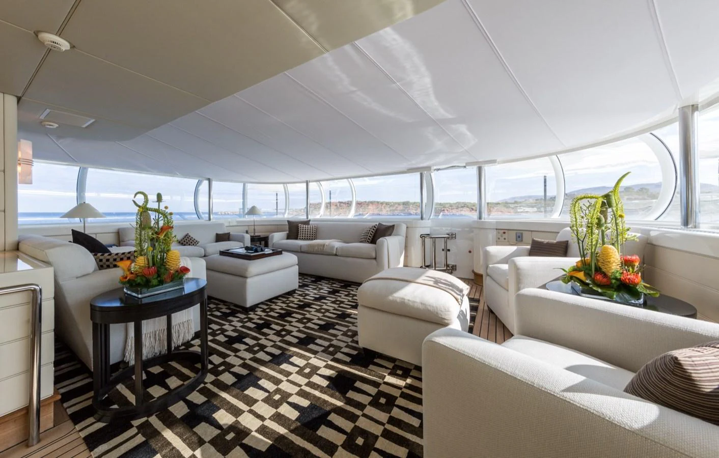 The spacious salon features plush seating and panoramic windows, offering a luxurious and comfortable environment. aboard ZEUS Yacht for Sale