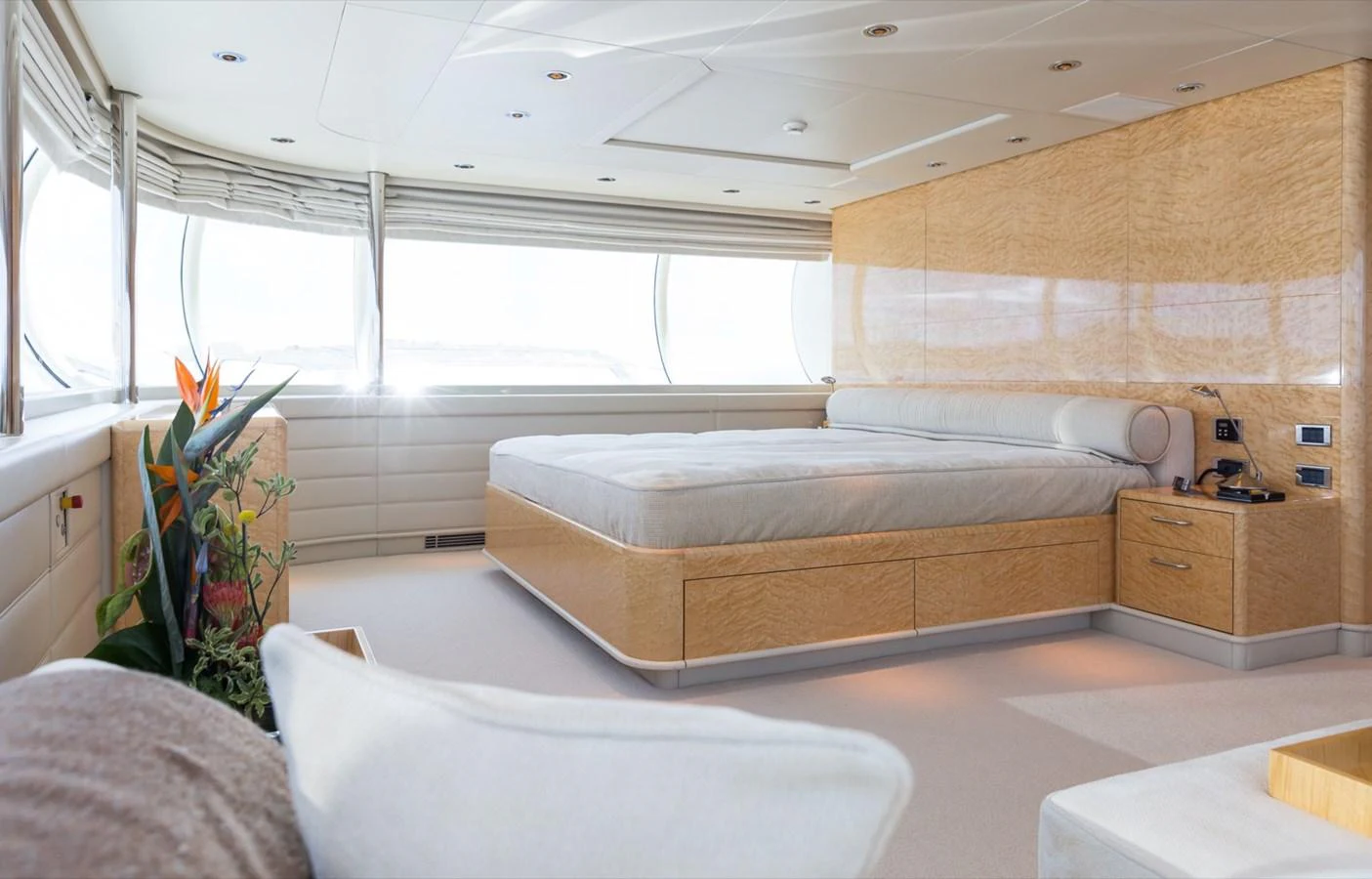 The master stateroom features a spacious bed, large windows, and elegant wood finishes. aboard ZEUS Yacht for Sale