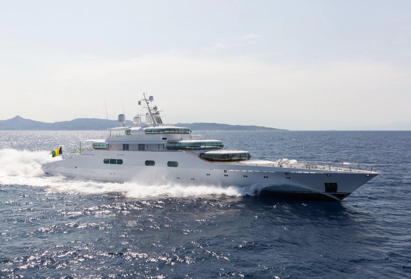 A sleek and modern yacht cruises swiftly across the open sea, showcasing its elegant design and powerful performance. aboard ZEUS Yacht for Sale