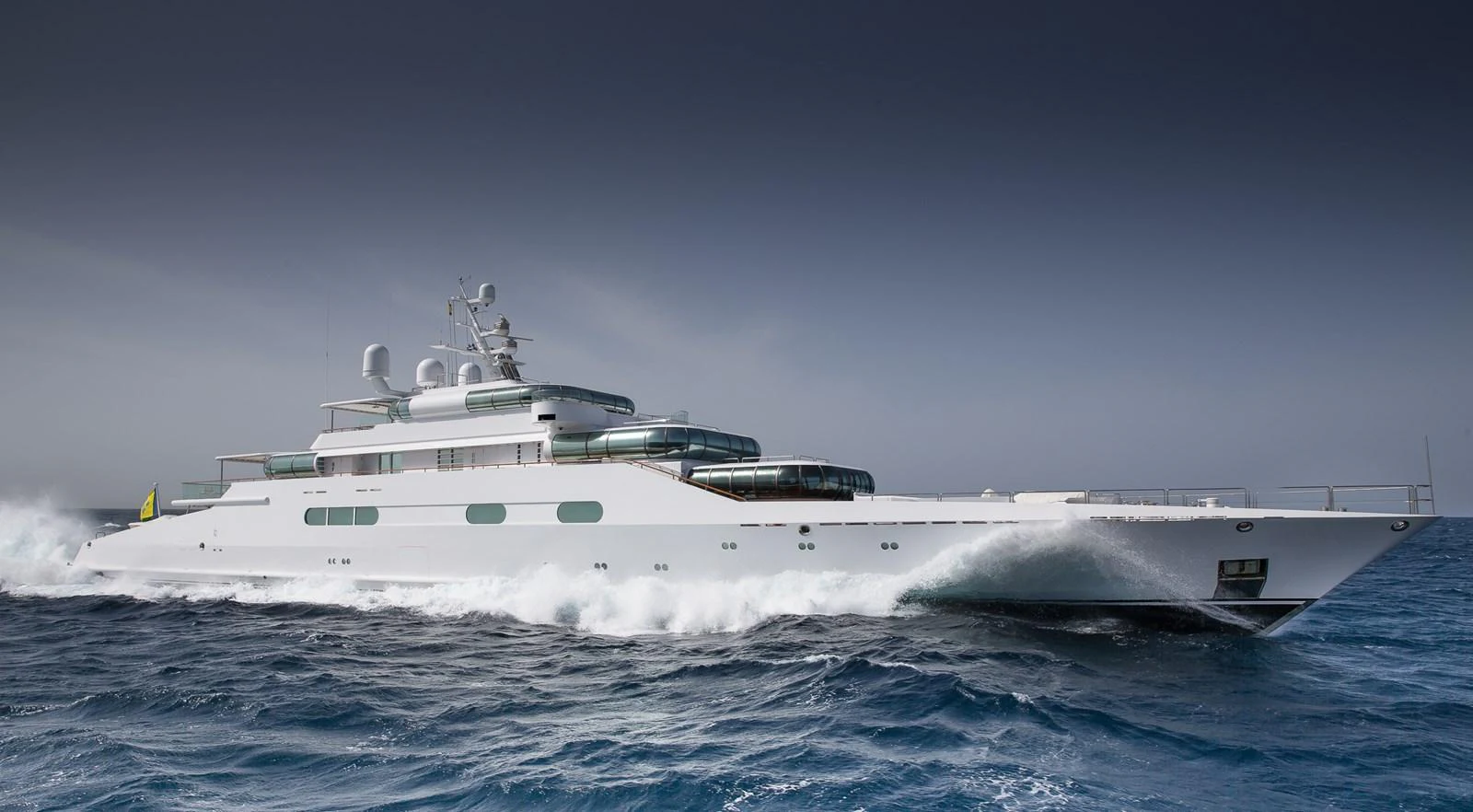 A sleek and modern yacht cruises through the open sea, showcasing its elegant design and powerful performance. aboard ZEUS Yacht for Sale