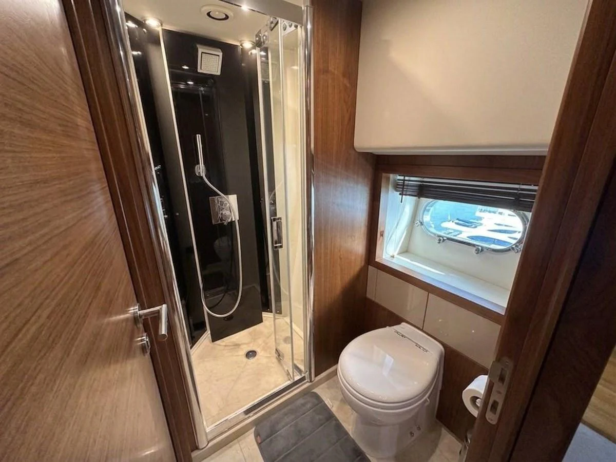 The yacht's bathroom features a sleek shower, modern fixtures, and a window with a view. aboard PELAGIA Yacht for Sale