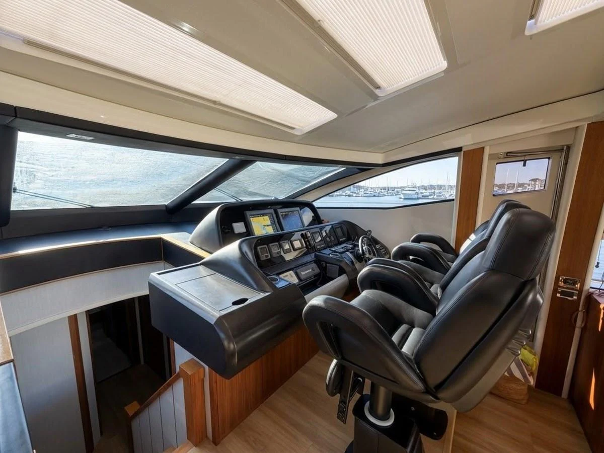 The helm station features luxurious leather seating and state-of-the-art navigation equipment. aboard PELAGIA Yacht for Sale