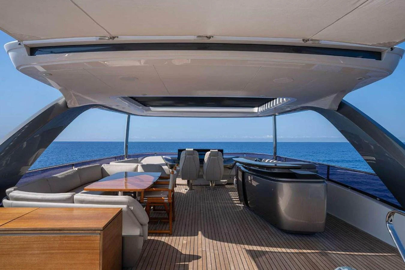 The flybridge offers a spacious and luxurious outdoor living area with ample seating and stunning ocean views. aboard AHAVA IV Yacht for Sale