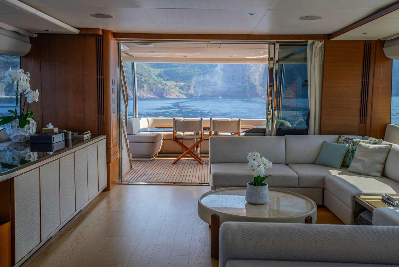 The salon offers a luxurious and spacious area with a stunning view of the sea through large sliding glass doors. aboard AHAVA IV Yacht for Sale