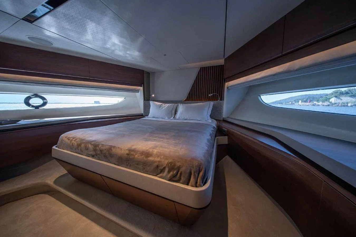 This luxurious stateroom features a large bed with panoramic windows offering stunning sea views. aboard AHAVA IV Yacht for Sale
