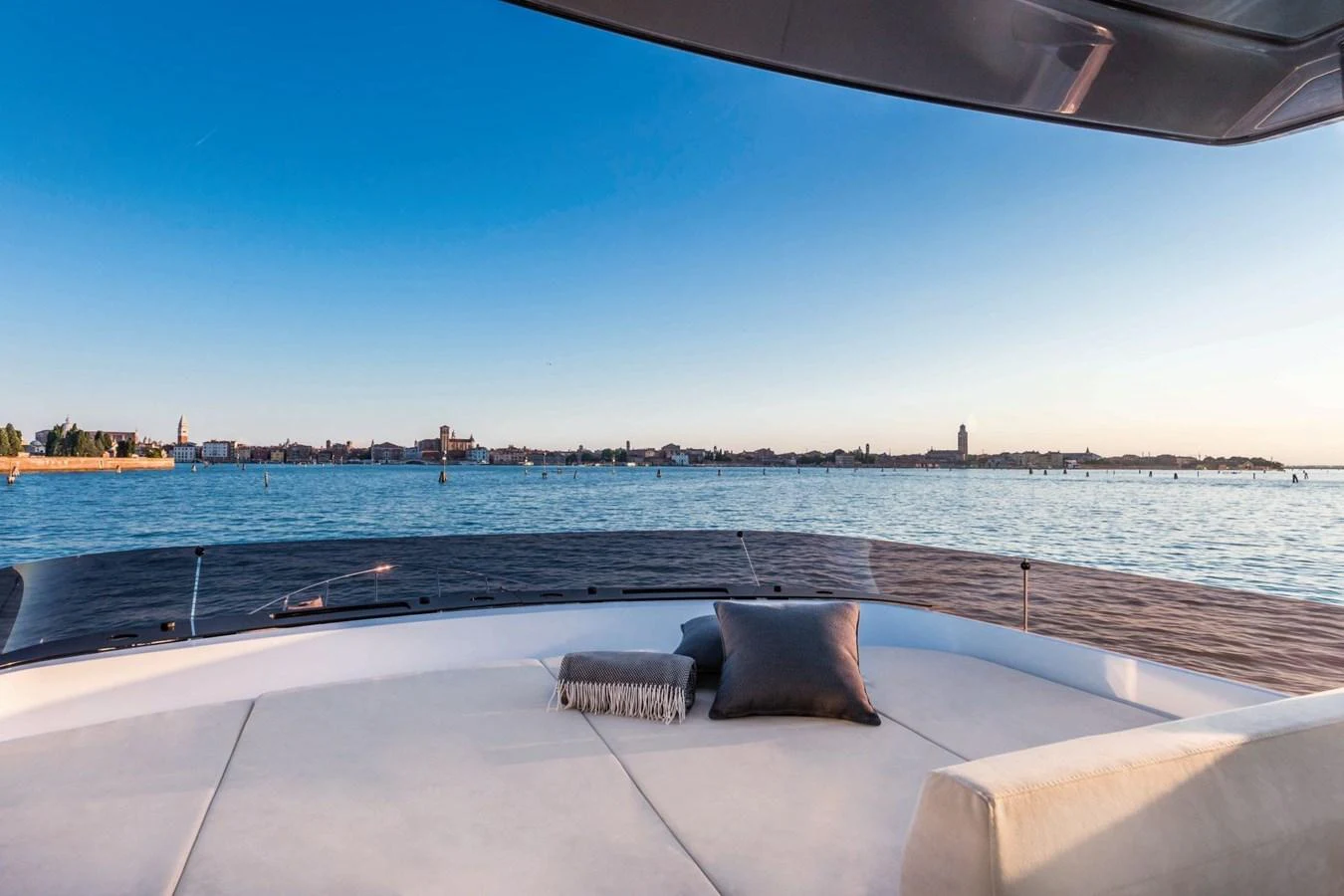 The yacht's bow offers a serene lounging area with a stunning view of the water and distant shoreline. aboard LIVI B Yacht for Sale