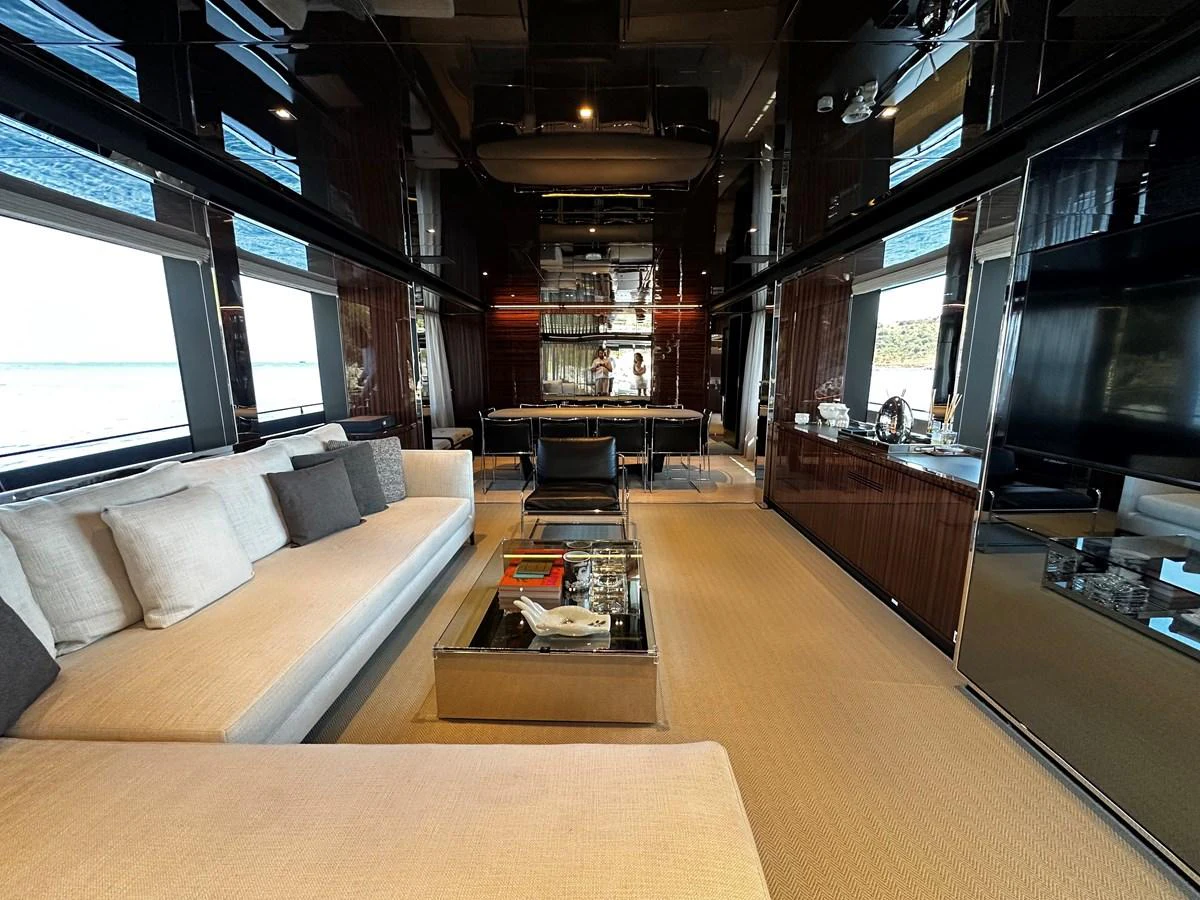 The salon features luxurious seating and a sophisticated ambiance with panoramic windows. aboard 4SEAS Yacht for Sale