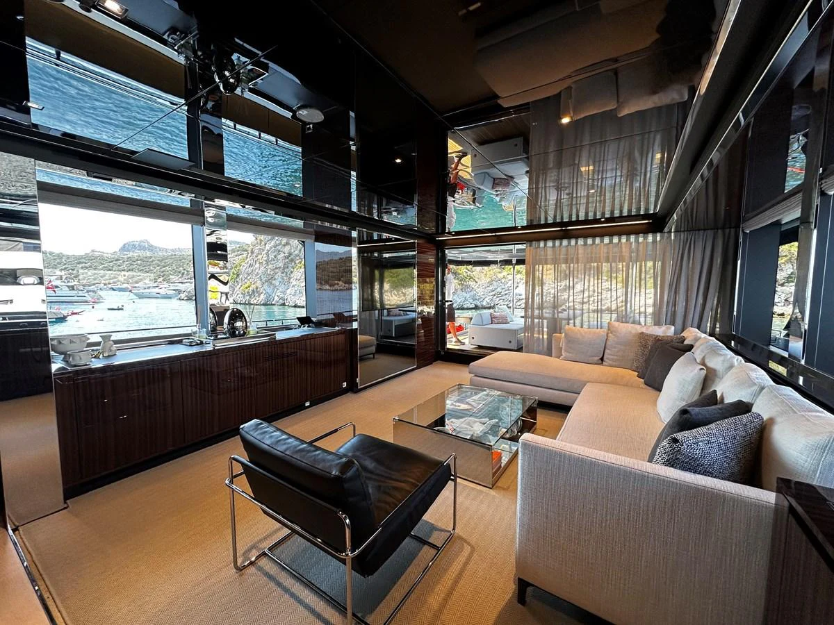 The salon features modern furnishings with expansive windows offering stunning views. aboard 4SEAS Yacht for Sale