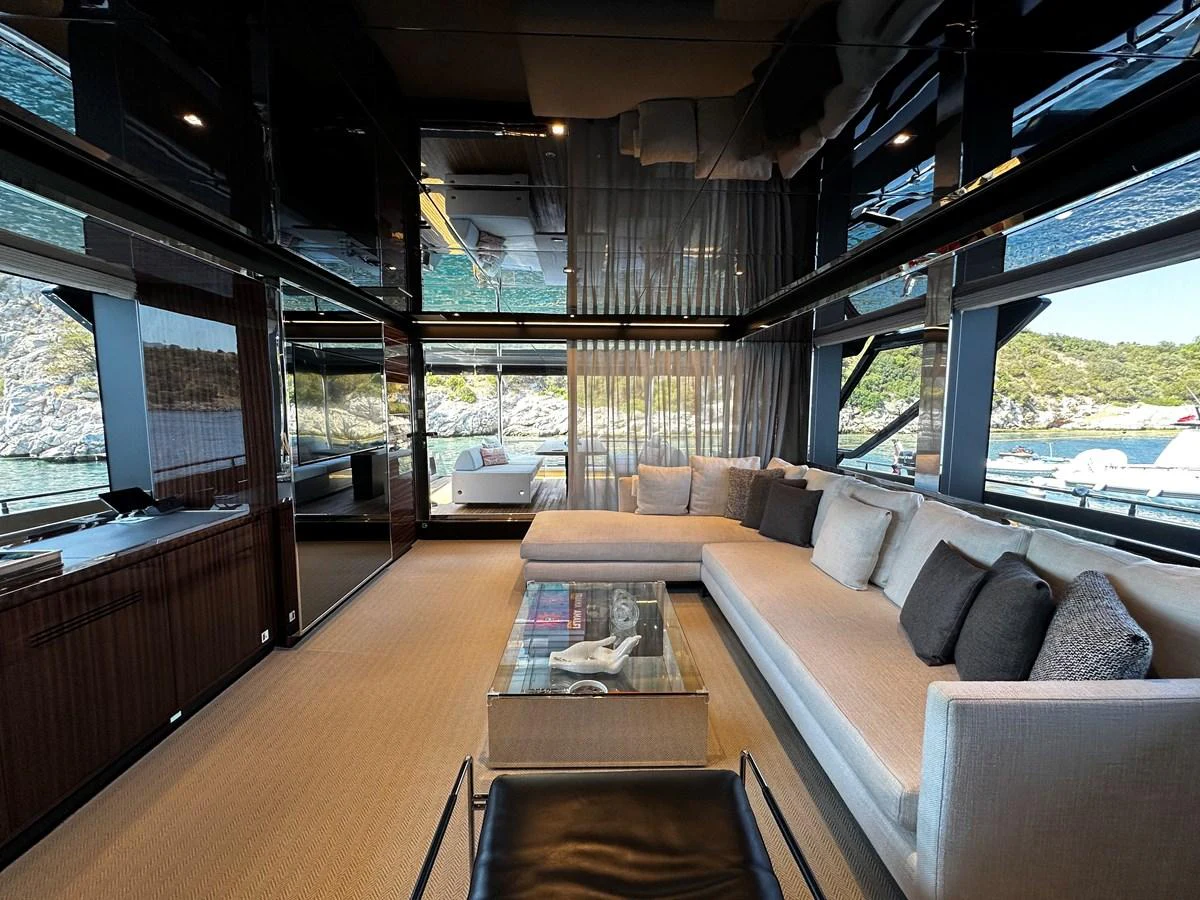 The salon features a spacious and elegant seating area with large windows offering stunning views. aboard 4SEAS Yacht for Sale