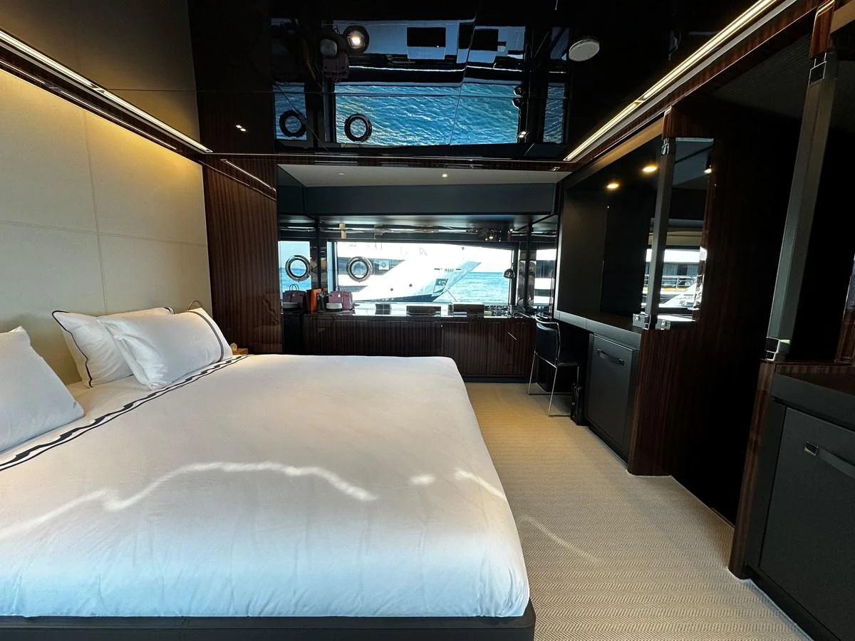 A luxurious stateroom featuring a large bed and modern furnishings. aboard 4SEAS Yacht for Sale